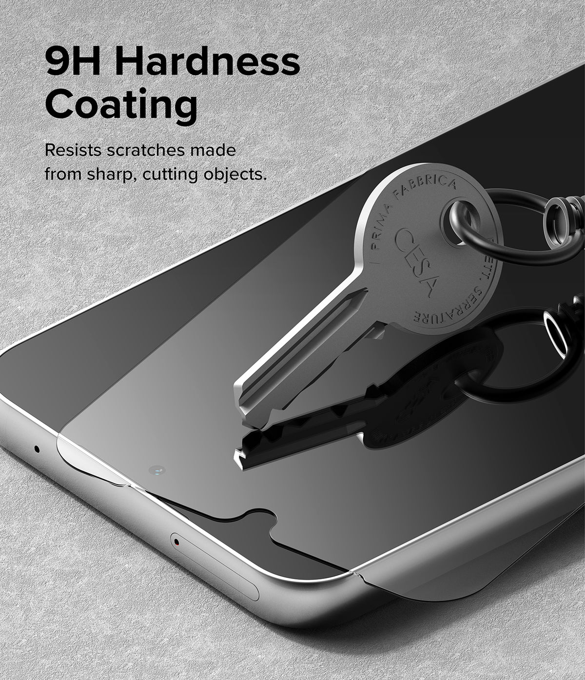 Galaxy A34 5G Screen Protector | Full Cover Glass - Galaxy A34 5G Screen Protector - A metal key resting on a phone screen protector, demonstrating 9H hardness scratch resistance.