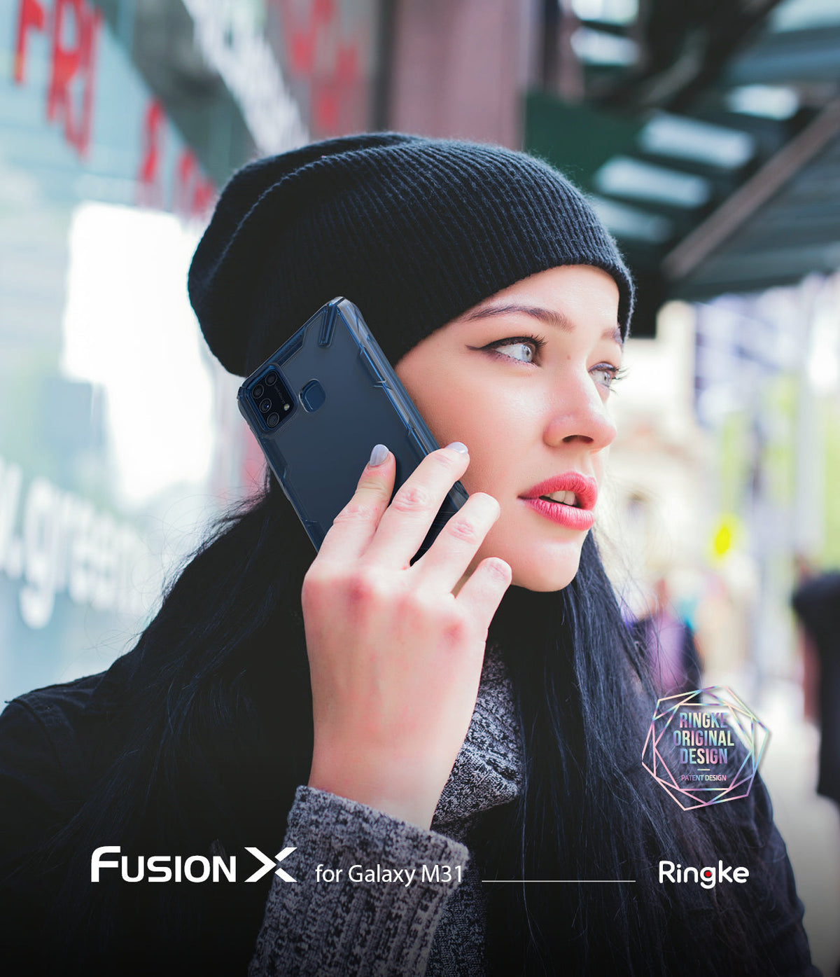 Galaxy M31 Case | Fusion-X - Woman in a beanie talking on a Galaxy M31 phone protected by a blue Fusion-X case.