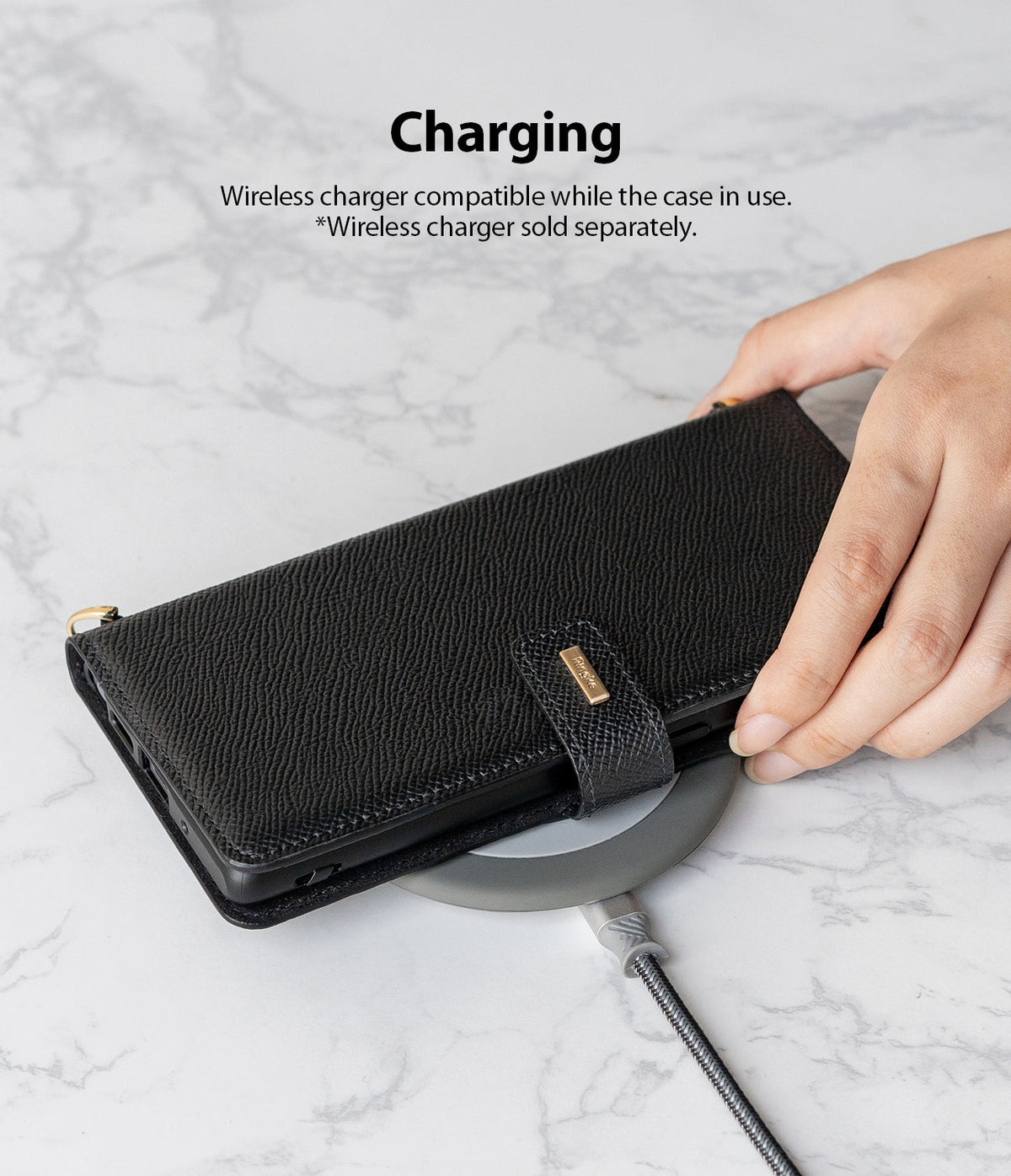 Galaxy Note 20 Ultra Case | Folio Signature Black - A hand places a black textured folio case onto a wireless charger.