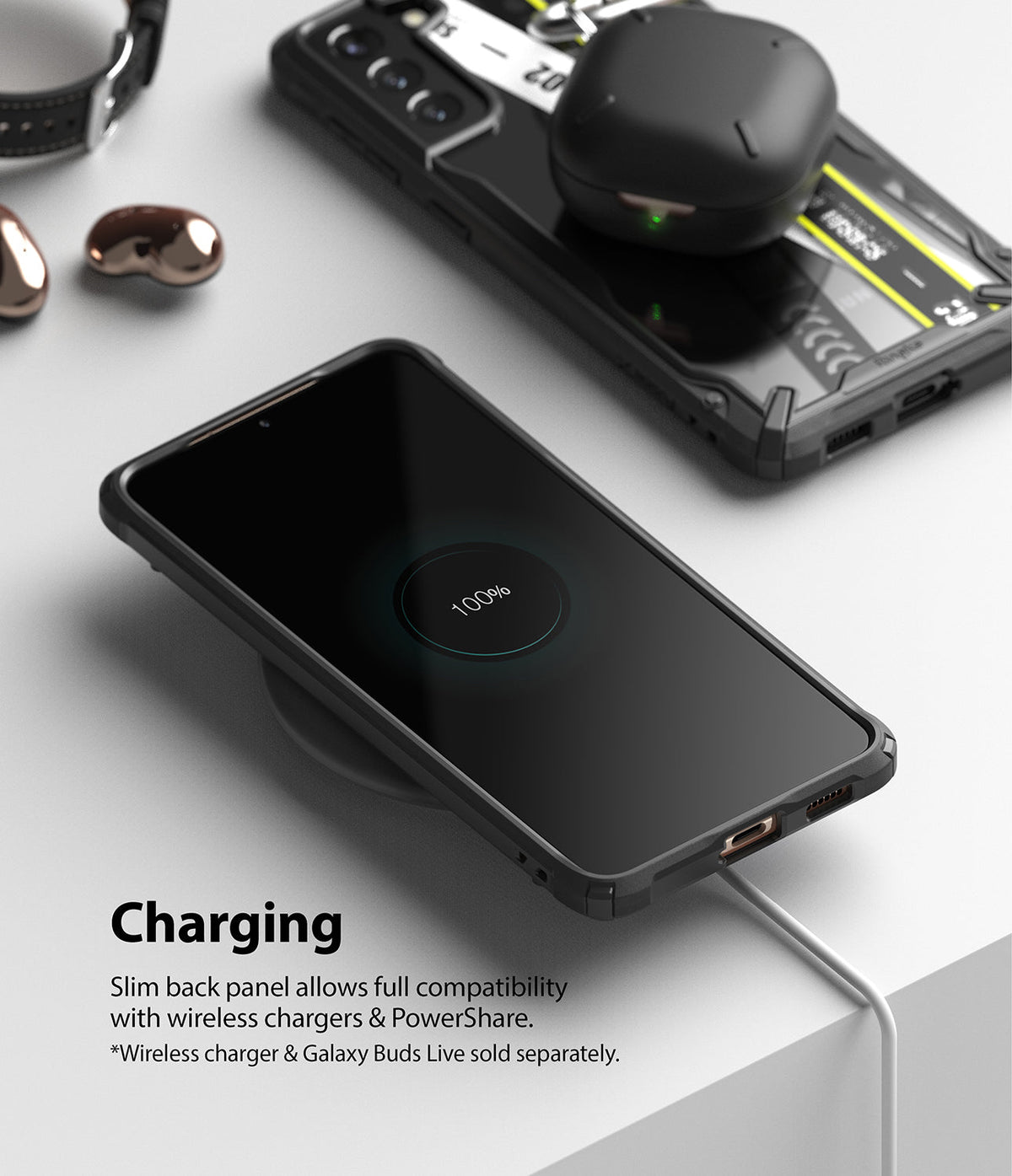 Galaxy S21 Case | Fusion-X Design - Smartphone in a rugged case wirelessly charging on a pad with earbuds nearby.