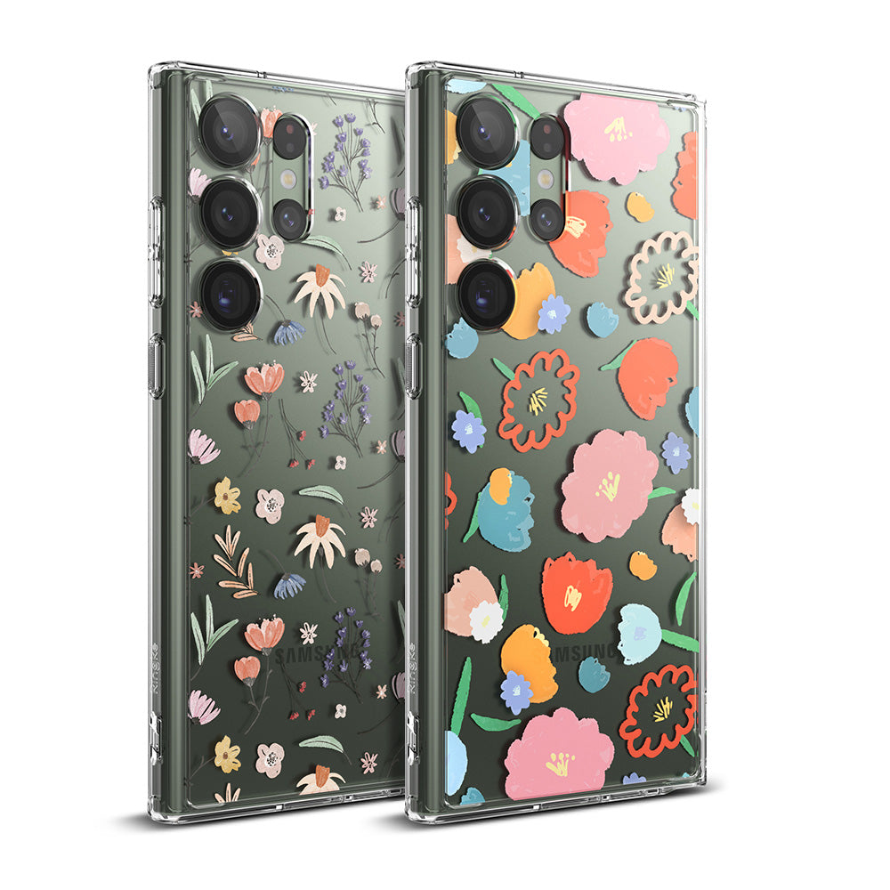 Galaxy S23 Ultra Case | Fusion Design - Two clear phone cases featuring colorful, artistic floral patterns on a green background.