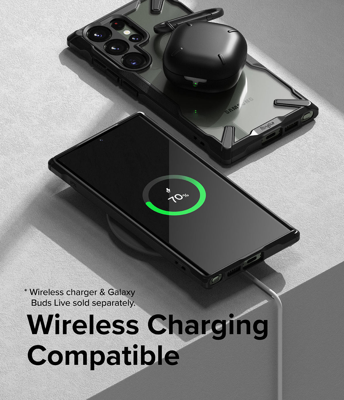 Galaxy S23 Ultra Case | Fusion-X - A phone in a black case wirelessly charging with earbuds resting on its back.