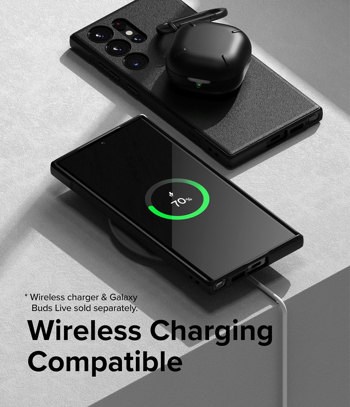 Galaxy S23 Ultra Case | Onyx - Black phone case on a wireless charger showing 70% charge with earbuds resting on top.