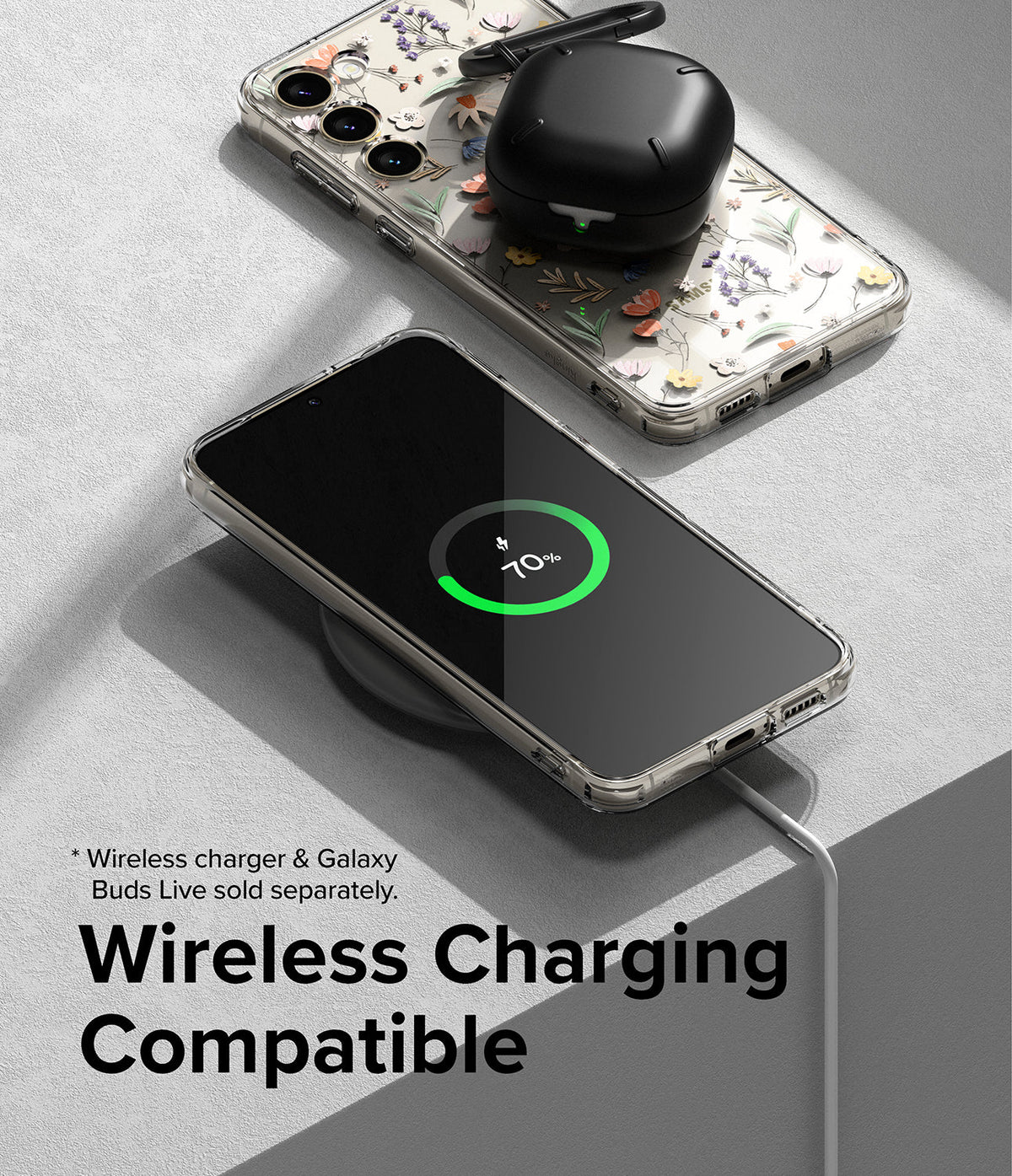 Galaxy S23 Case | Fusion Design - Clear floral phone case on a wireless charger with a charging phone and earbuds case.