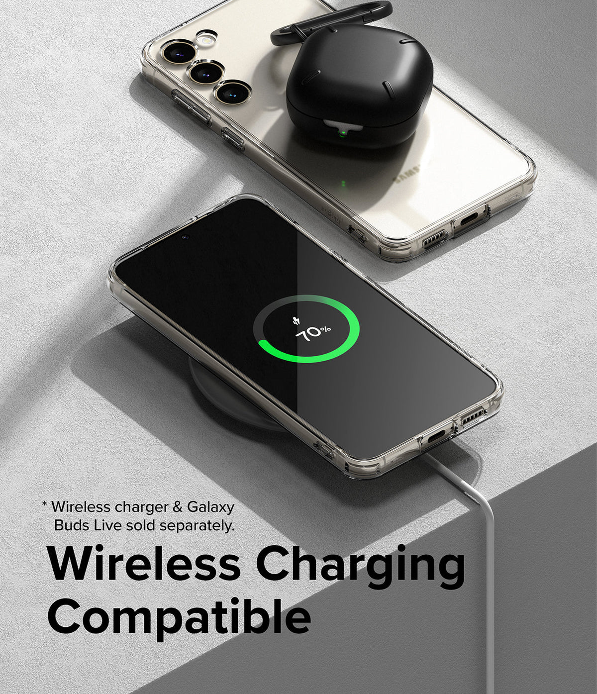 Galaxy S23 Case | Fusion - Clear phone case on a wireless charger with a charging Galaxy S23 and black earbuds case.