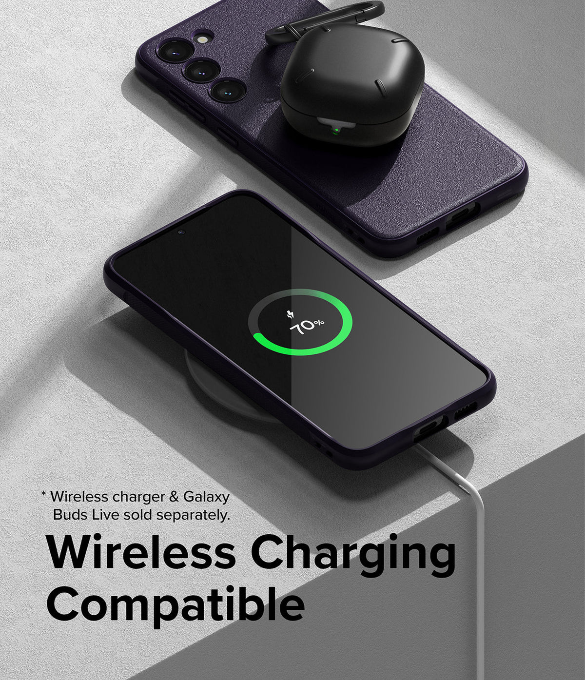 Galaxy S23 Case | Onyx - A dark purple Galaxy S23 case on a wireless charger with a charging phone and earbuds case nearby.