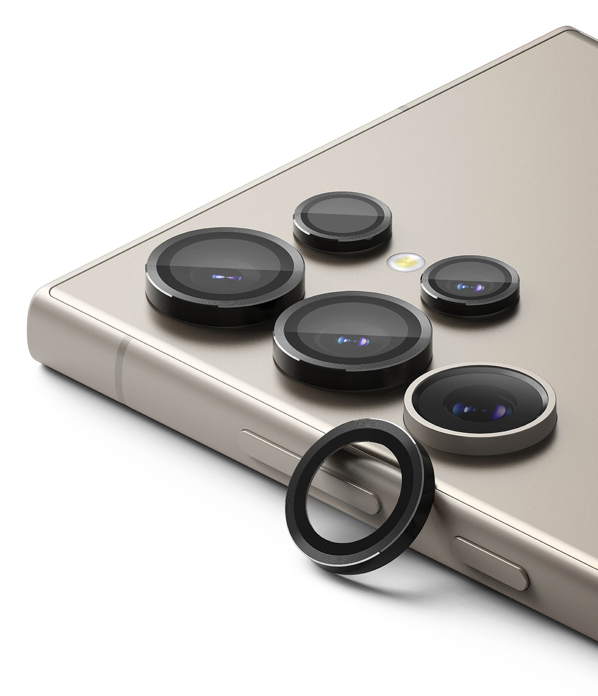 Galaxy S24 Ultra Lens Protector | Camera Lens Frame Glass - Galaxy S24 Ultra Lens Protector - Black metal camera lens covers installed on a beige smartphone with one spare ring.