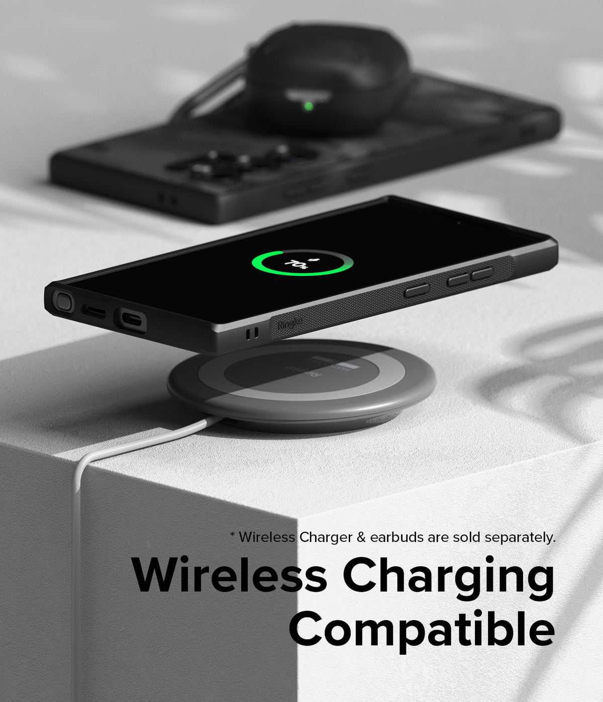 Galaxy S24 Ultra Case | Onyx Design - Black phone in textured case wirelessly charging on a circular pad with earbuds nearby.