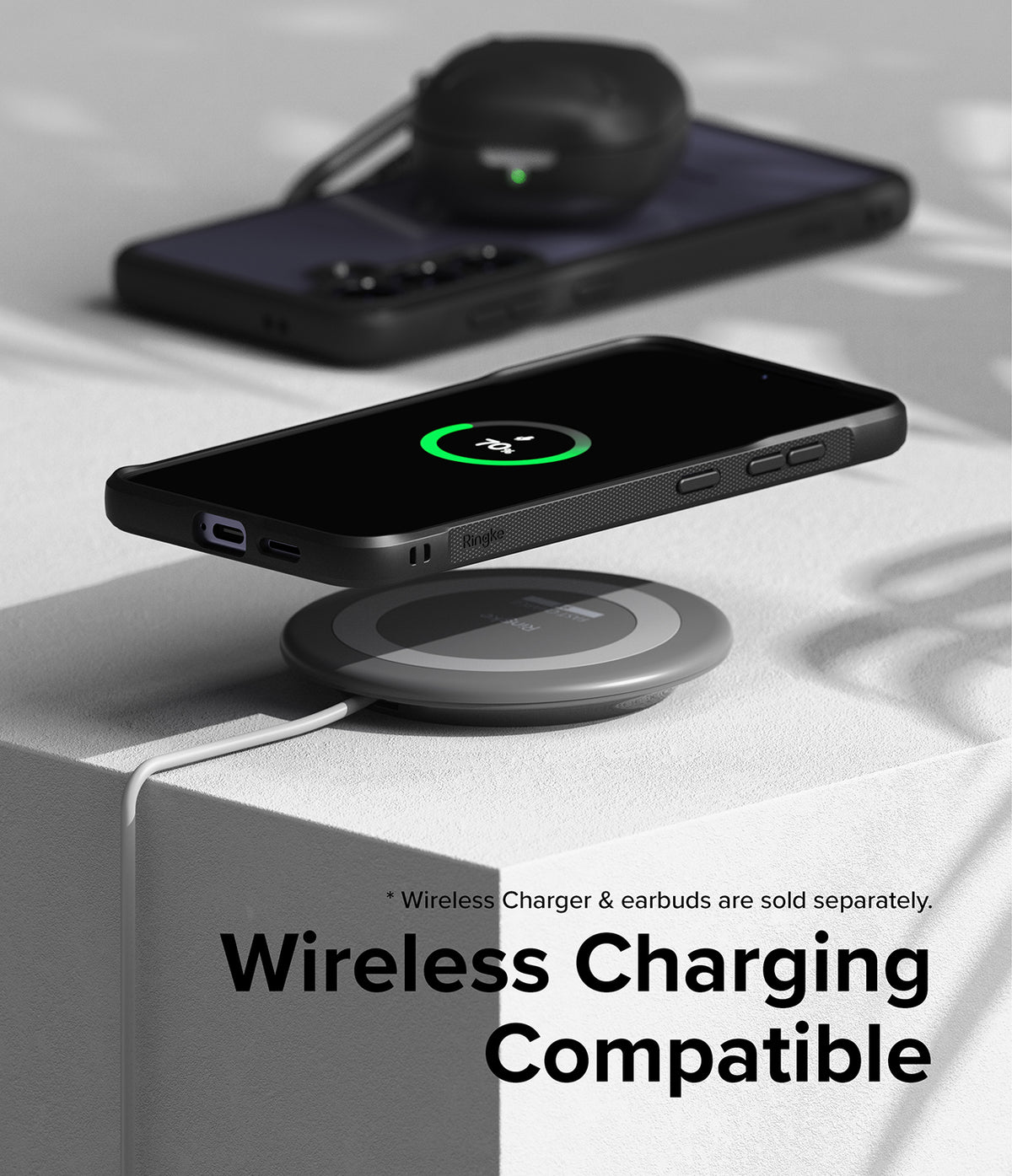 Galaxy S24 Case | Fusion Bold - A black phone in a protective case wirelessly charging on a circular pad.