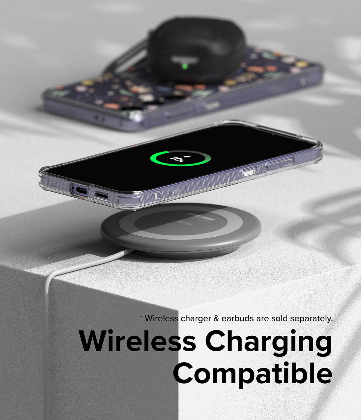 Galaxy S24 Plus Case | Fusion Design - Galaxy S24 Plus in a clear case wirelessly charging on a pad with earbuds nearby.