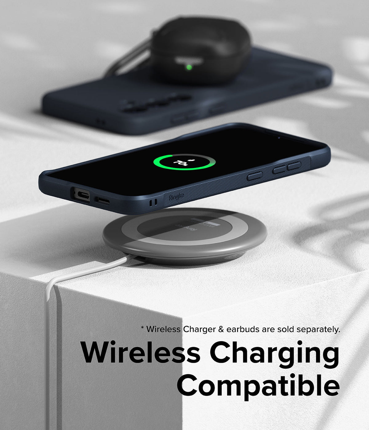 Galaxy S24 Case | Onyx - A dark blue phone case on a wireless charger showing a 70% charge icon on the screen.
