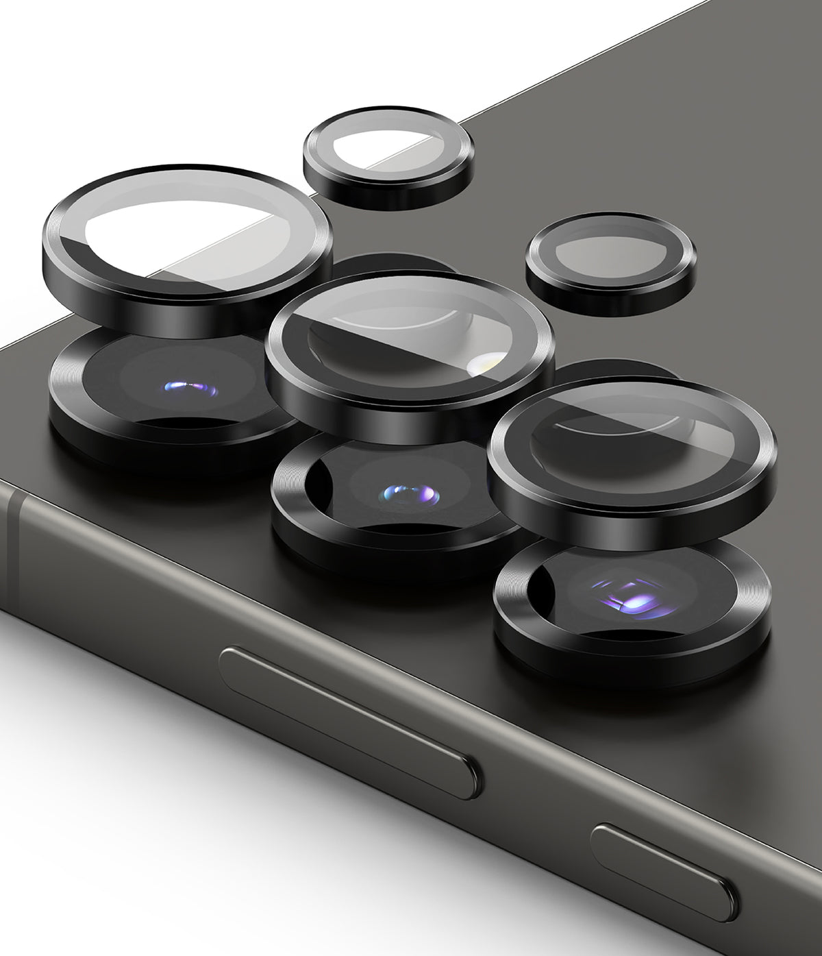 Galaxy S25 Ultra | Camera Lens Frame Glass - Galaxy S25 Ultra | Black metal camera lens protectors hovering above the smartphone's rear camera array.