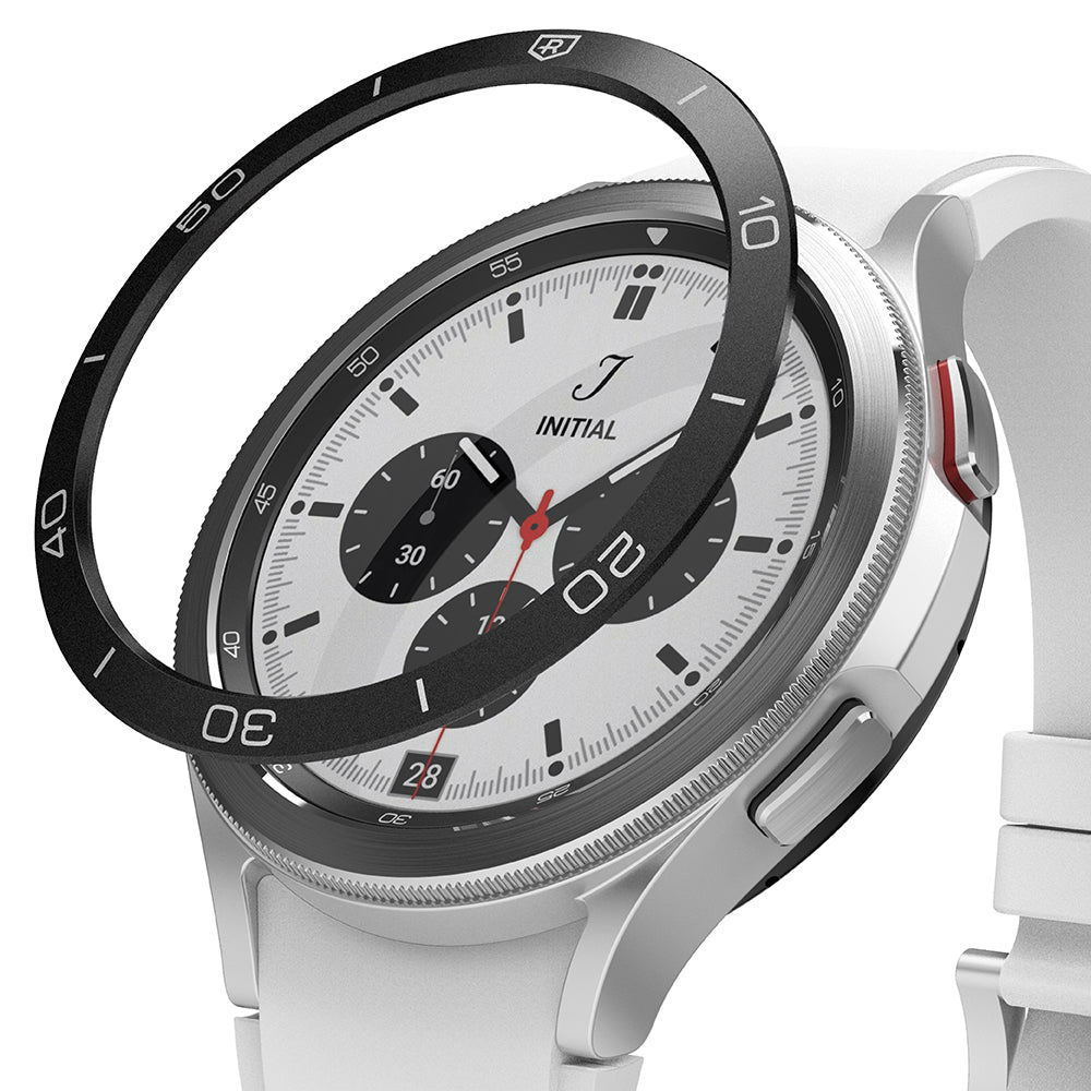 Galaxy Watch 4 Classic 42mm | Bezel Styling - Black adhesive bezel ring hovering above a silver smartwatch with white band.