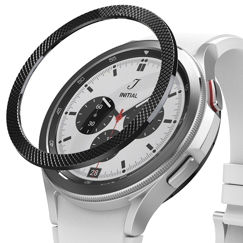 Galaxy Watch 4 Classic 42mm | Bezel Styling - A black textured bezel ring hovering above a silver smartwatch with a white band.