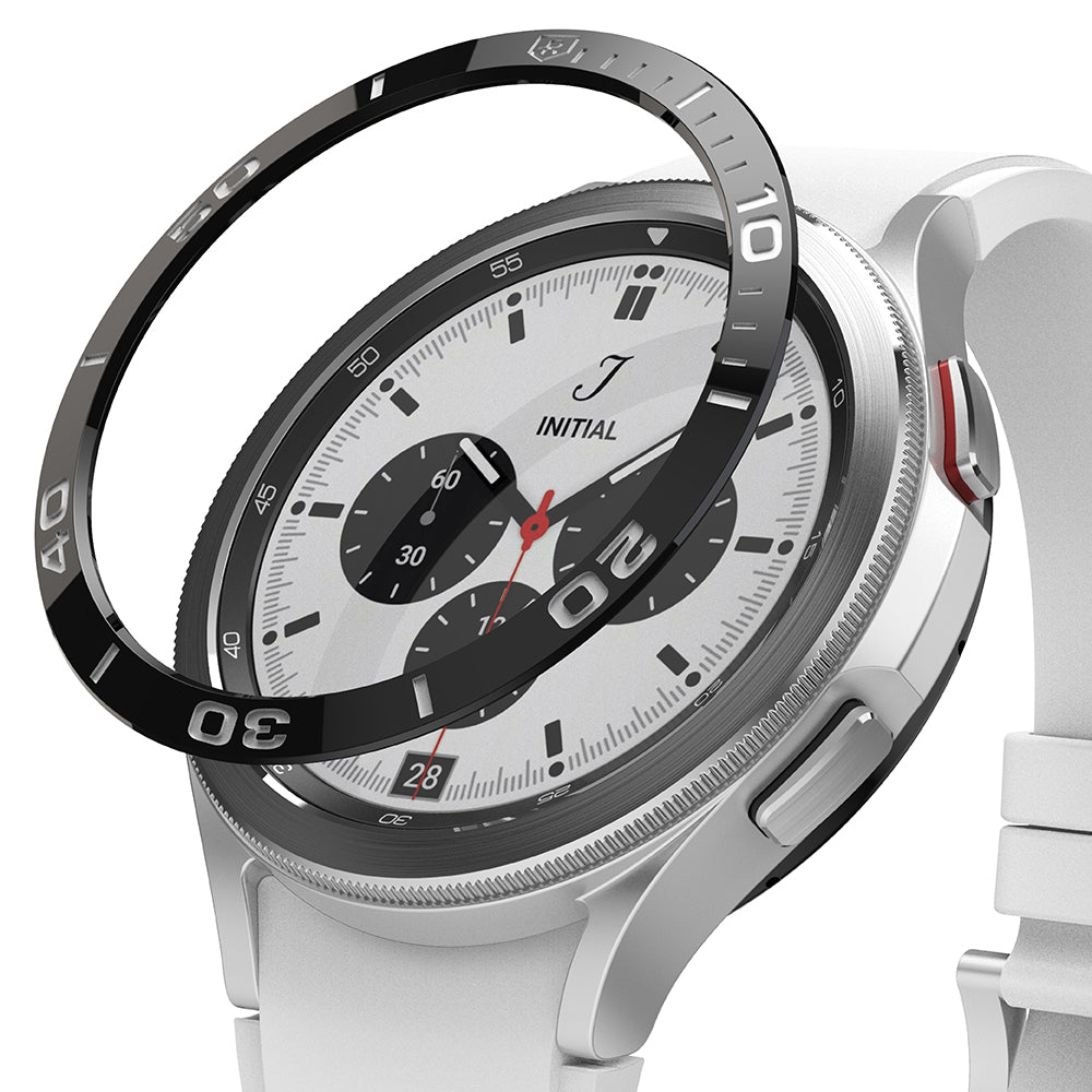Galaxy Watch 4 Classic 46mm | Bezel Styling - A black numbered bezel ring hovering above a silver smartwatch with a white band.