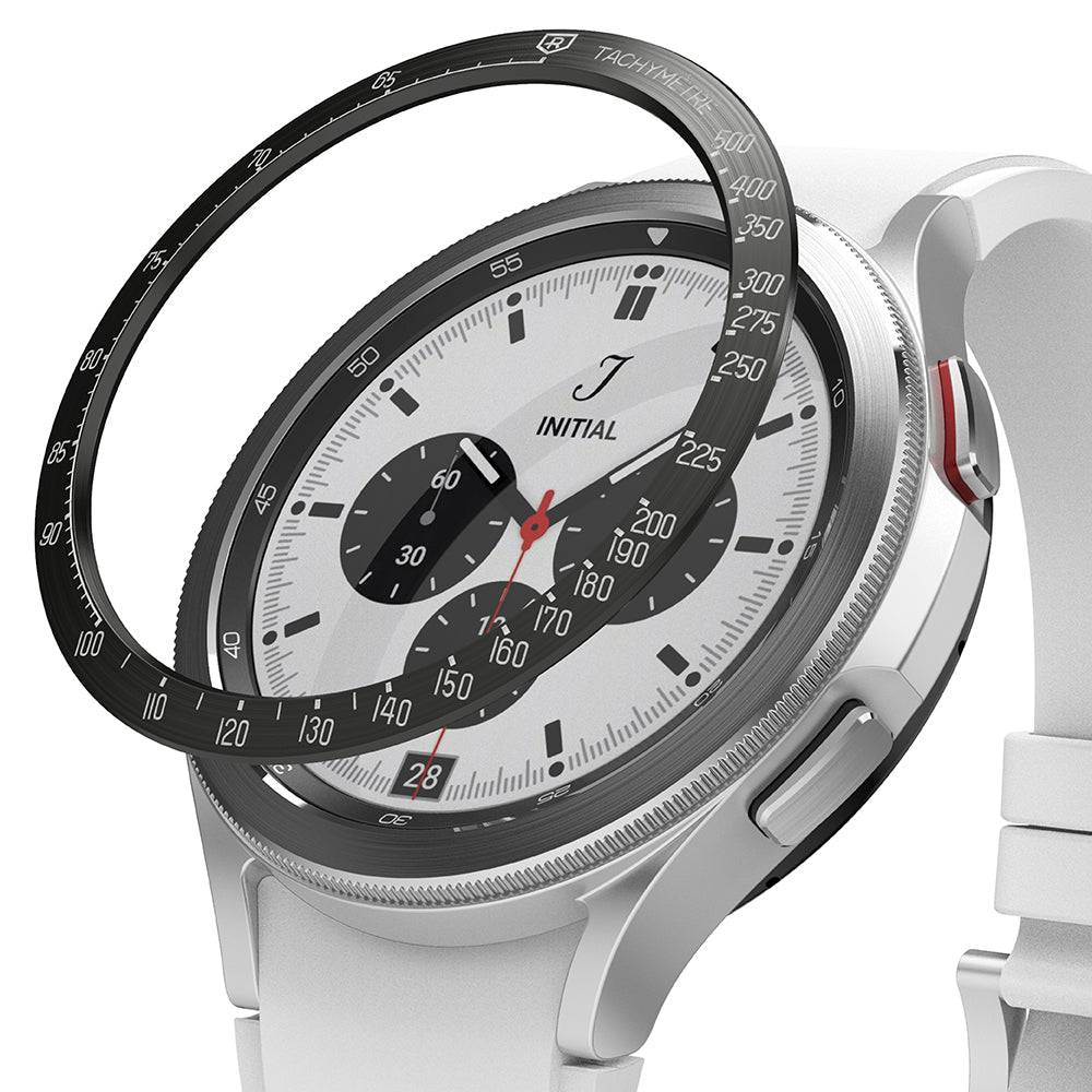 Galaxy Watch 4 Classic 46mm | Bezel Styling - Galaxy Watch 4 Classic 46mm | Black tachymeter bezel ring hovering above a silver smartwatch with a white chronograph face.