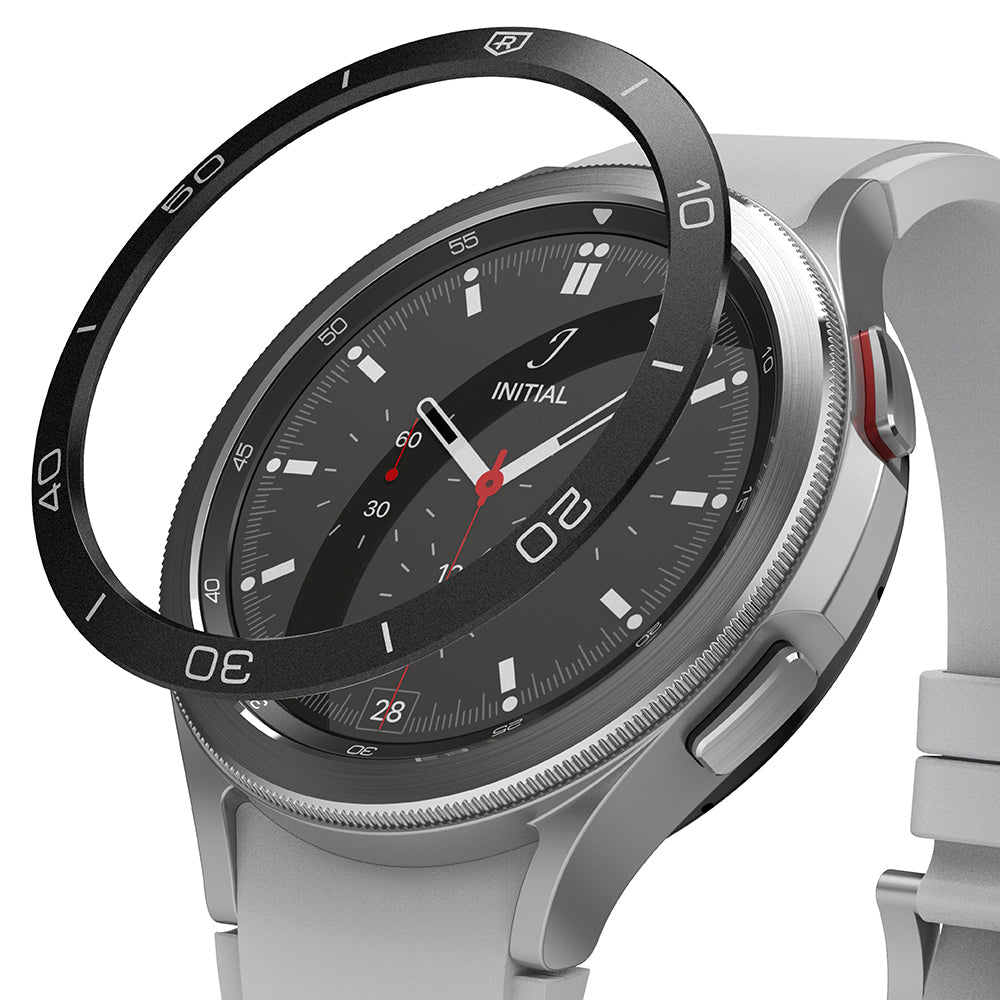 Galaxy Watch 4 Classic 46mm | Bezel Styling - A black adhesive bezel ring hovering above a silver Galaxy Watch 4.