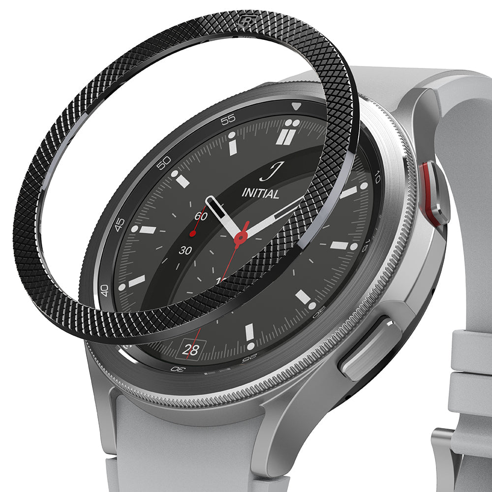 Galaxy Watch 4 Classic 46mm | Bezel Styling - A black textured metal bezel ring hovering above a silver smartwatch.