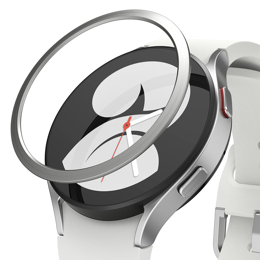 Galaxy Watch 5/4 40mm | Bezel Styling - A metallic silver bezel ring hovering above a white smartwatch with a black screen.