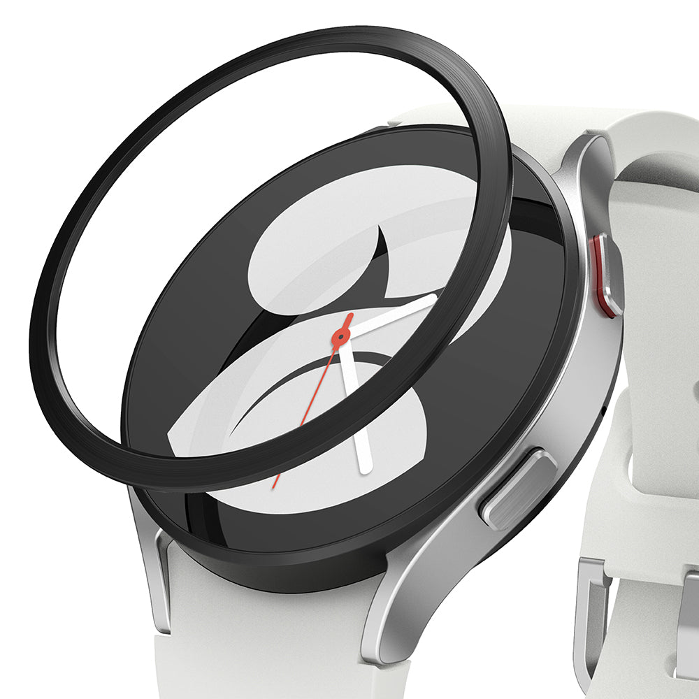 Galaxy Watch 5/4 40mm | Bezel Styling - A black adhesive bezel ring hovering above a silver Galaxy Watch with a white strap.