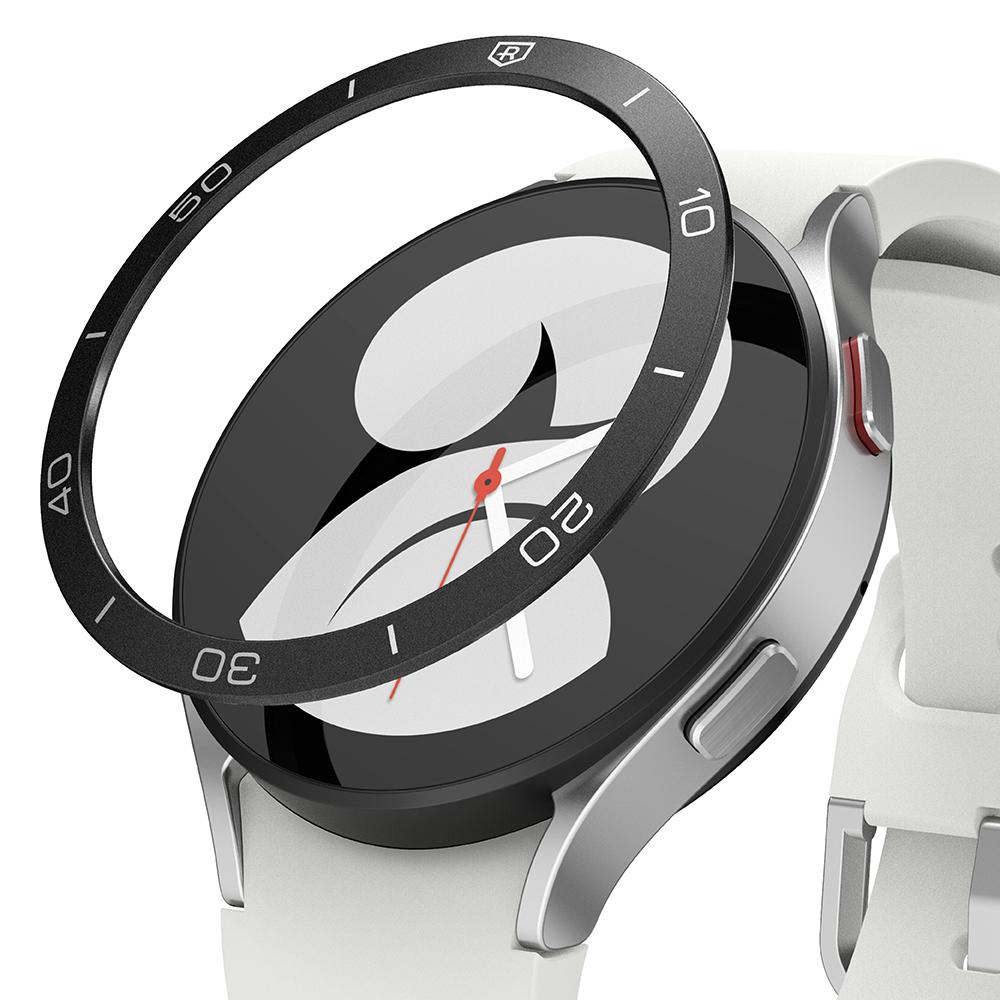 Galaxy Watch 5/4 40mm | Bezel Styling - Black adhesive bezel ring hovering above a silver smartwatch with a white band.