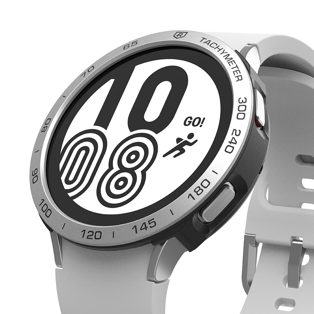 Galaxy Watch 4 44mm | Air Sports Black + Bezel Styling - Galaxy Watch 4 44mm - Silver Galaxy Watch 4 with a tachymeter bezel styling and a white sports band showing a digital clock.