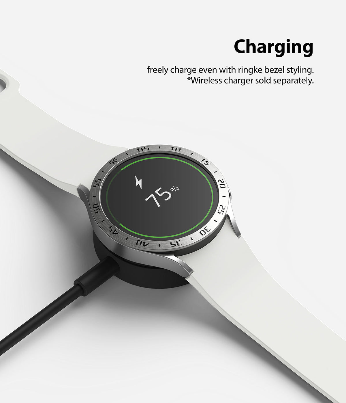 Galaxy Watch 5/4 44mm | Bezel Styling - A smartwatch with a silver bezel accessory charging on a wireless dock.