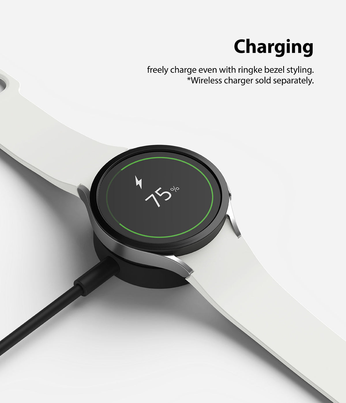 Galaxy Watch 5/4 44mm | Bezel Styling - A smartwatch with a black bezel ring charging on a wireless dock at 75% battery.
