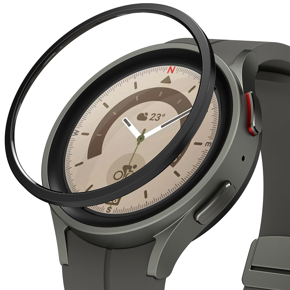 Galaxy Watch 5 Pro 45mm | Bezel Styling - A black adhesive bezel ring hovering above a grey Galaxy Watch 5 Pro.