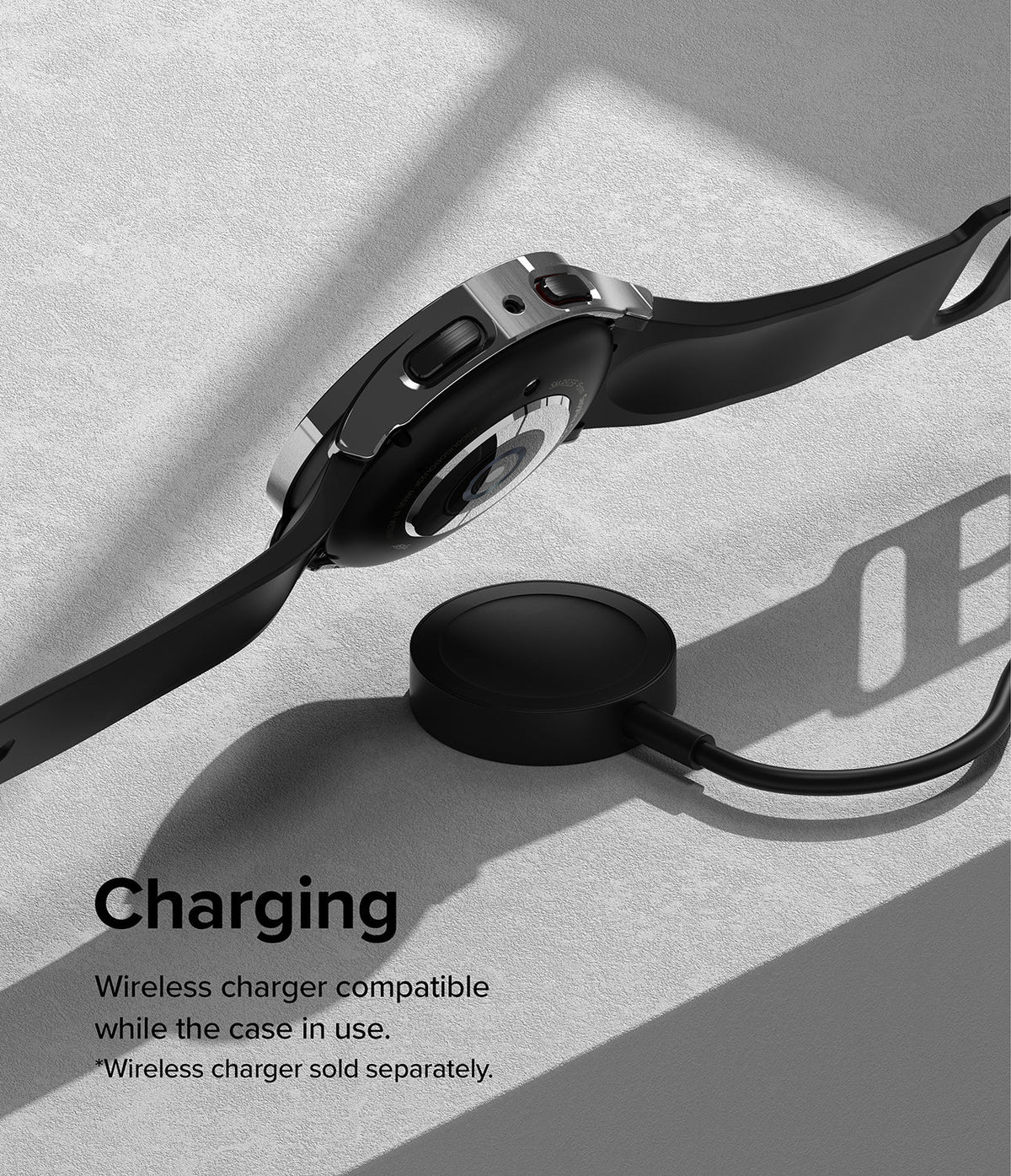 Galaxy Watch 5 Pro Case | Slim - A Galaxy Watch 5 Pro with a slim case hovering above a wireless charging puck on a gray surface.