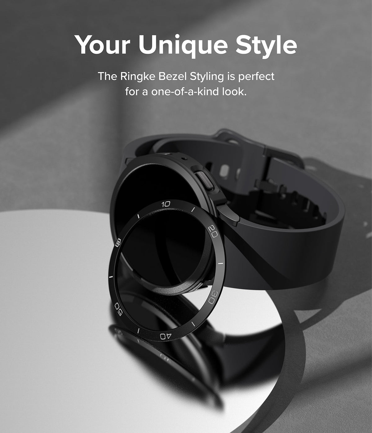 Galaxy Watch 5 40mm | Air Sports Black + Bezel Styling - Galaxy Watch 5 40mm - Black smartwatch with a separate numbered metal bezel ring resting on a reflective surface.