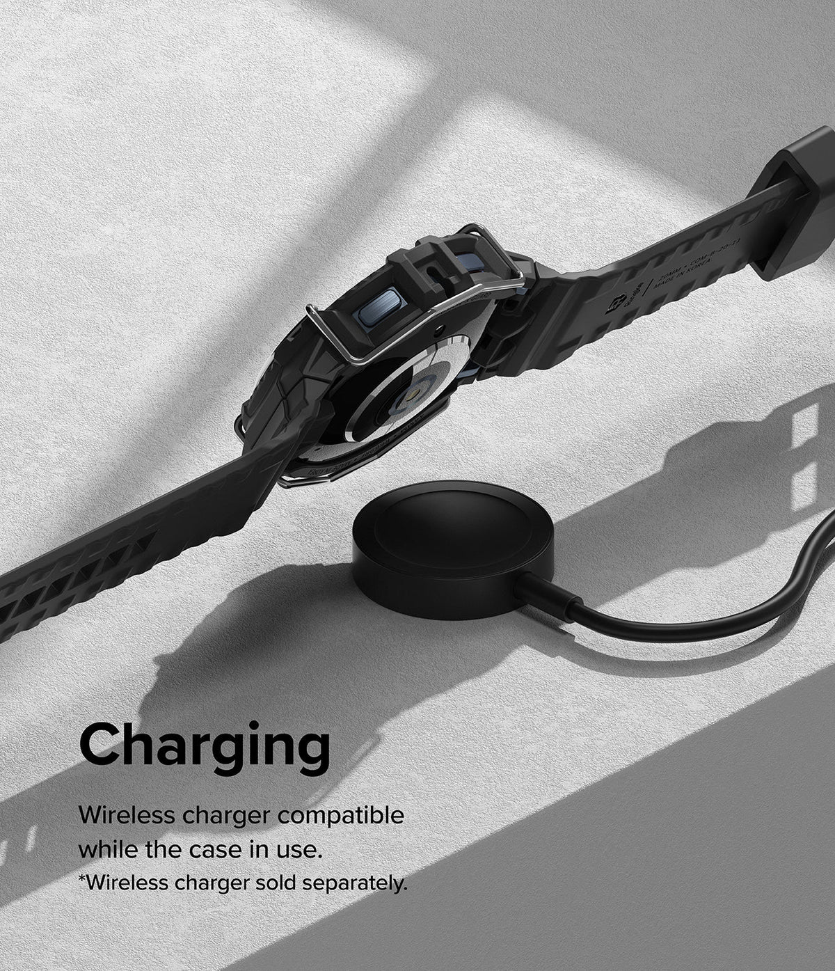Galaxy Watch 5 / 4 (44mm) Case + Band + Wire | Fusion-X Guard - Black smartwatch in rugged case charging on wireless pad.