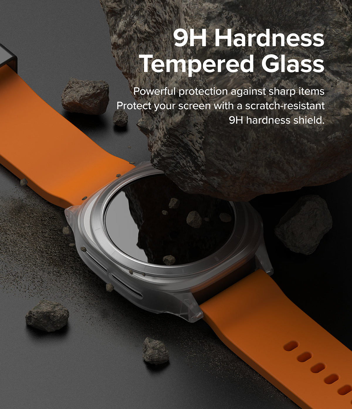 Galaxy Watch Ultra | Slim Extend & Glass - A smartwatch with an orange band sits under a large rock to demonstrate 9H tempered glass screen protection.
