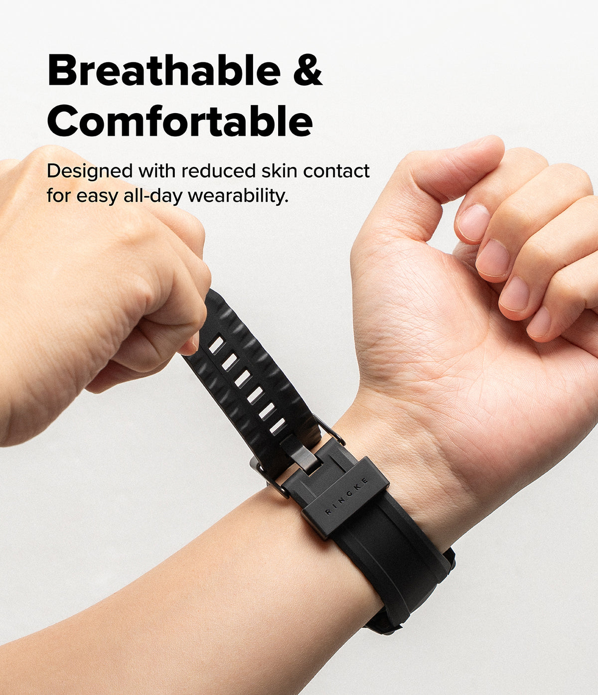 Galaxy Watch 8 Classic 46mm Case + Band | Rugged Gear - Hands adjusting a black, textured silicone watch band on a wrist.