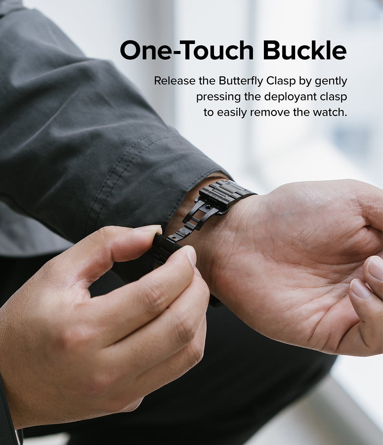 Google Pixel Watch | Metal One Band - Hands opening the black metal watch band's butterfly clasp on a wrist.