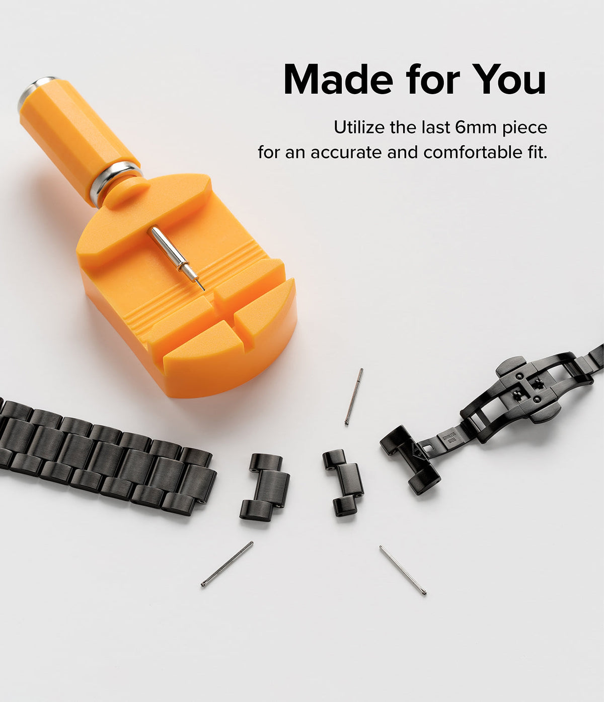 Google Pixel Watch | Metal One Band - A yellow watch link removal tool next to a disassembled black metal watch band.