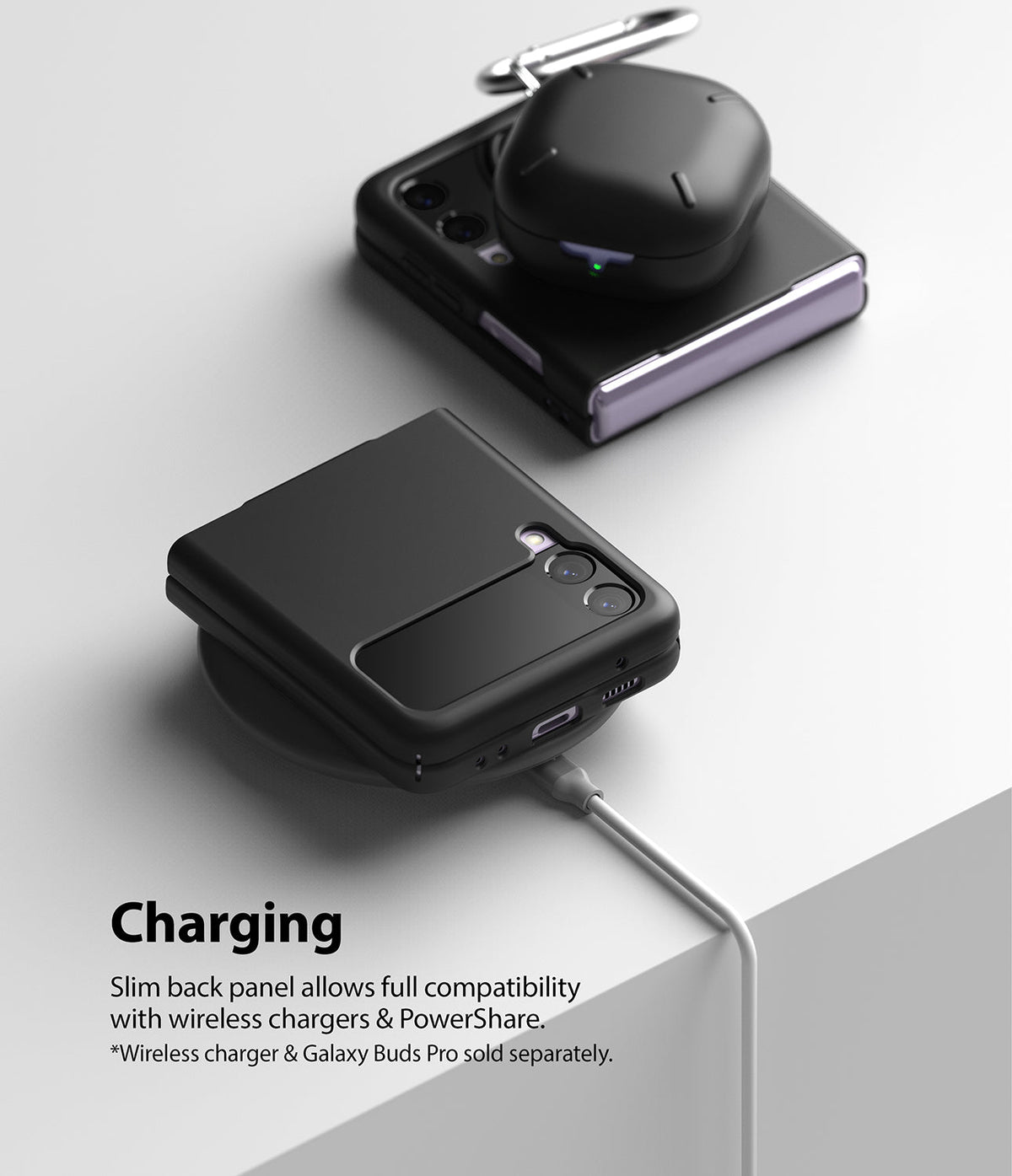 Galaxy Z Flip 3 Case | Slim - Black case on a wireless charger with Galaxy Buds Pro resting on a second folded phone.