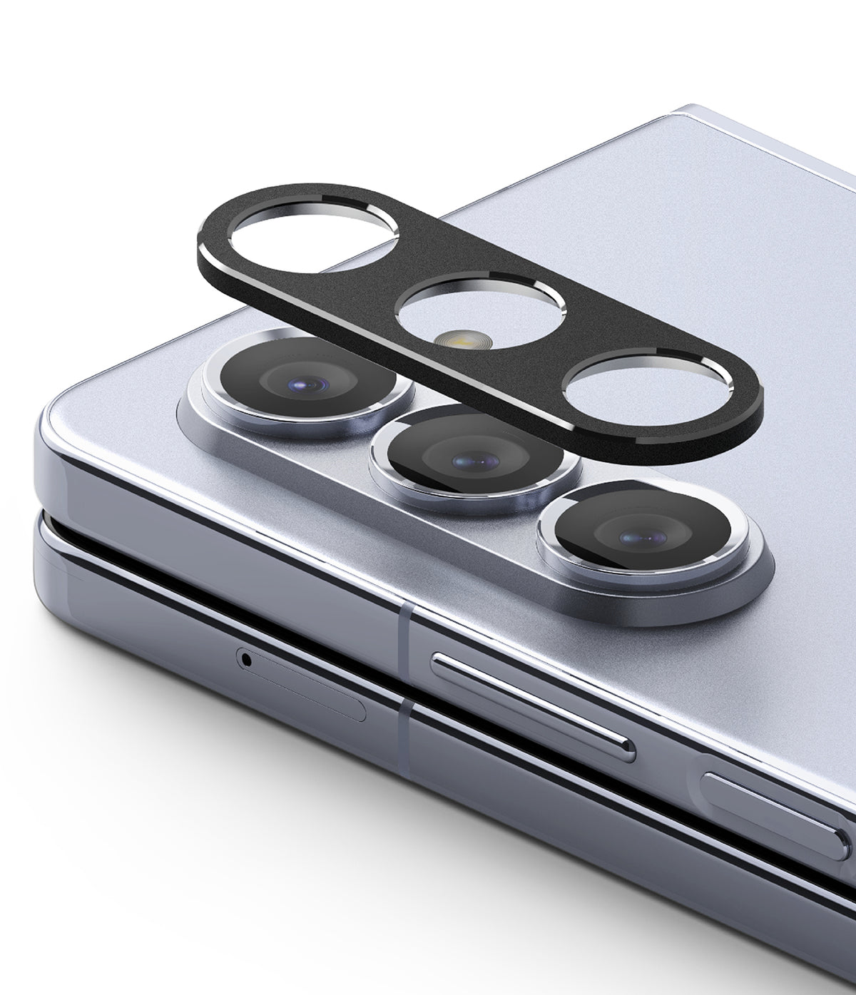 Galaxy Z Fold 5 | Camera Styling - A black protective camera lens cover hovering above the triple lenses of a silver phone.