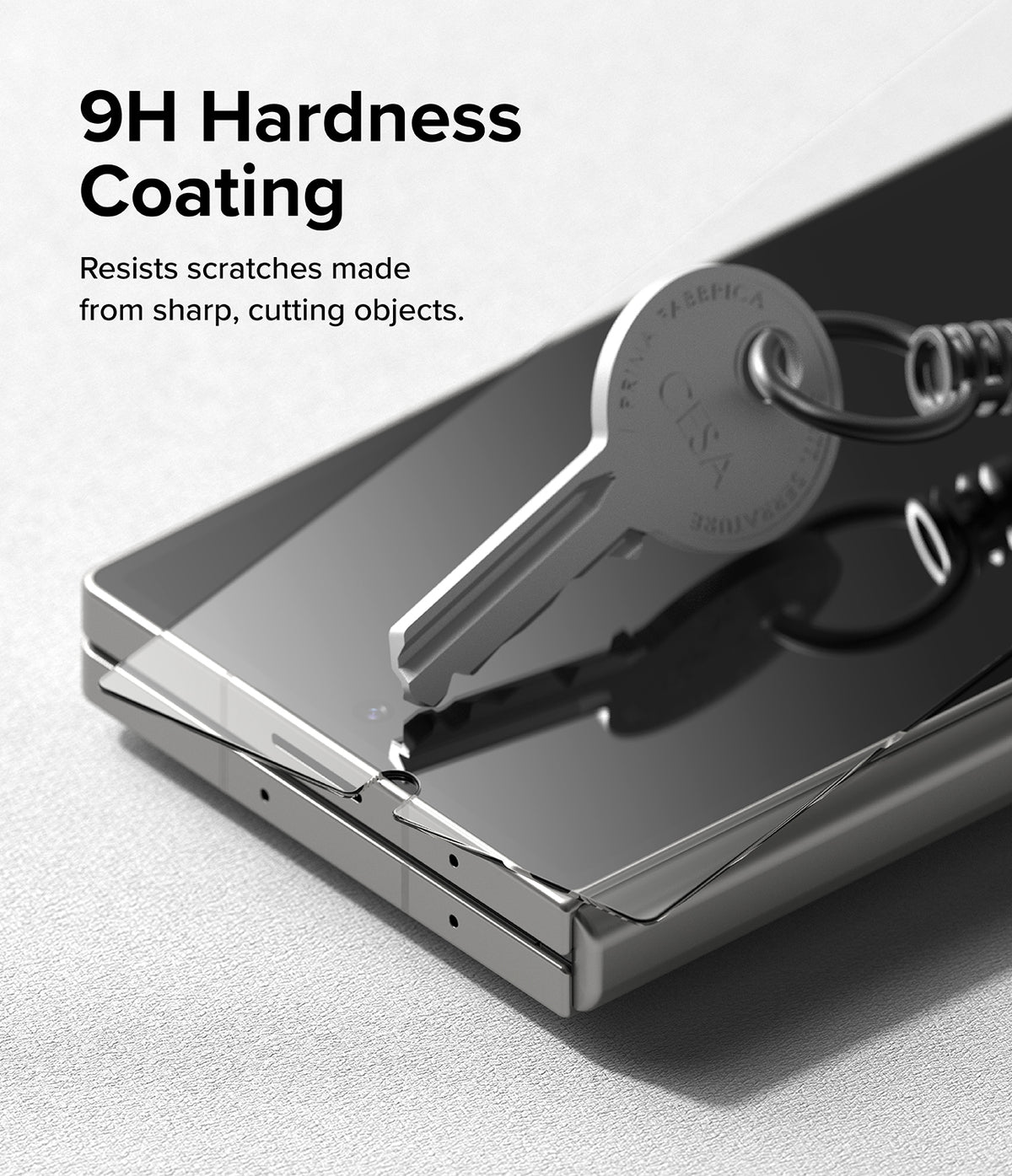 Galaxy Z Fold 6 | 3-in-1 Protector - A metal key pressing against a screen protector on a Galaxy Z Fold 6 to show scratch resistance.