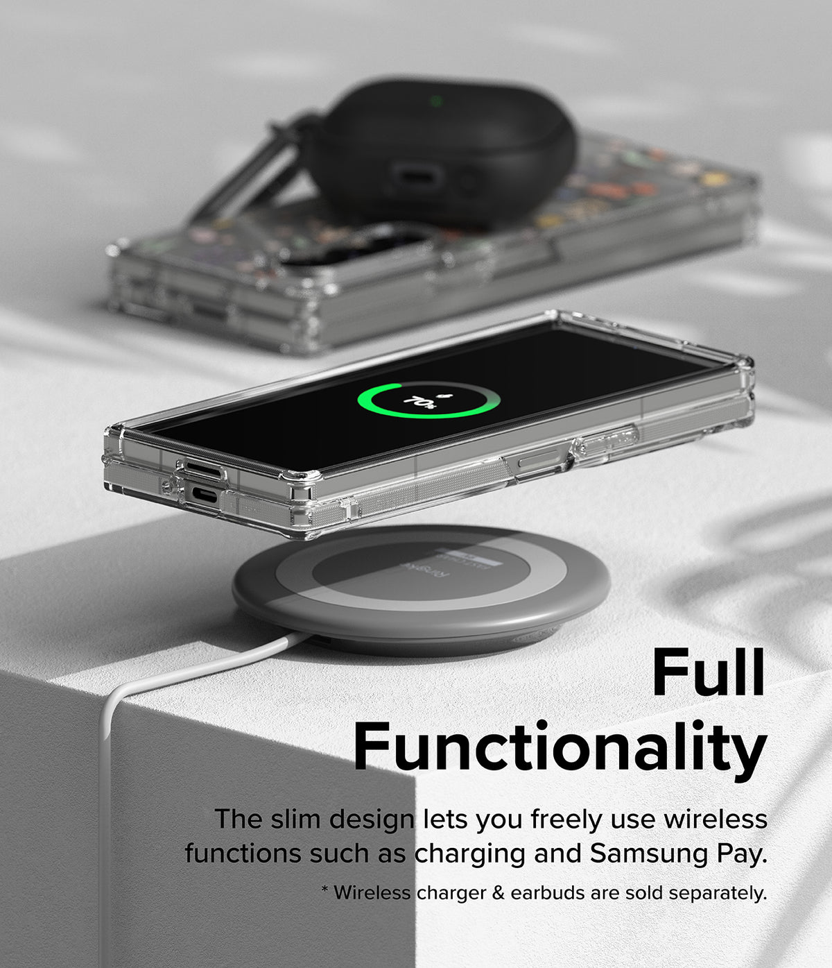 Galaxy Z Fold 6 case | Fusion Design - Folded phone in clear case wirelessly charging on a pad with earbuds nearby.
