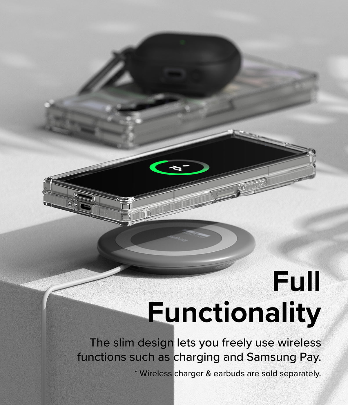 Galaxy Z Fold 6 case | Fusion Design - Foldable phone in a clear case wirelessly charging on a pad with earbuds nearby.