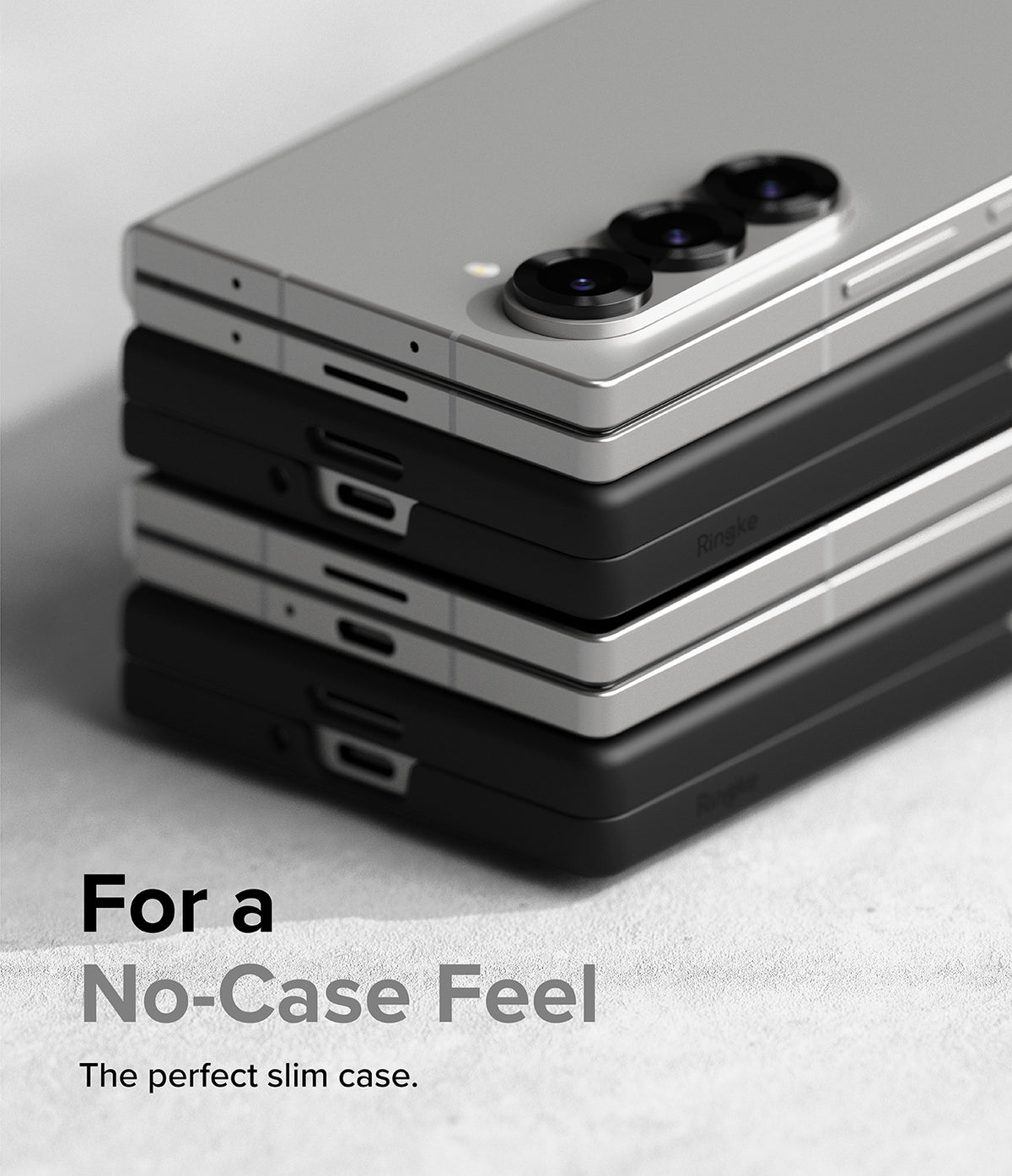 Galaxy Z Fold 6 Case | Slim - A stack of silver and black Galaxy Z Fold 6 phones with slim cases on a textured surface.