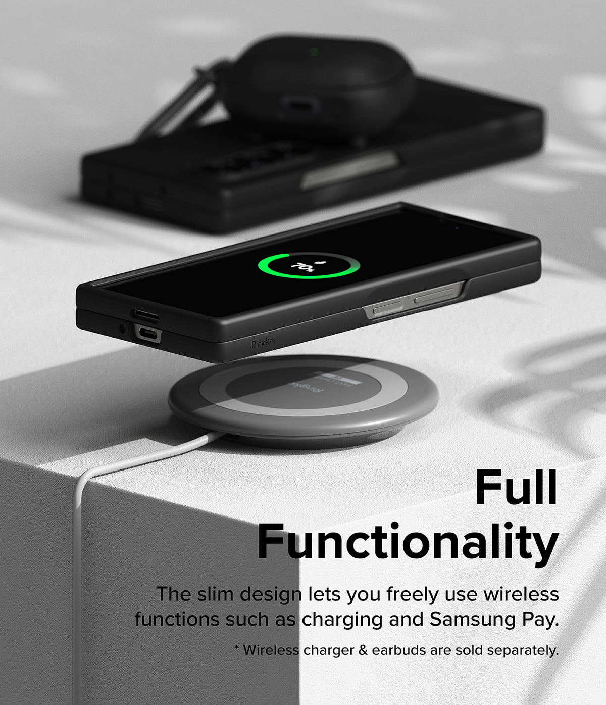 Galaxy Z Fold 6 Case | Slim - A black phone in a slim case wirelessly charging on a circular pad with earbuds nearby.