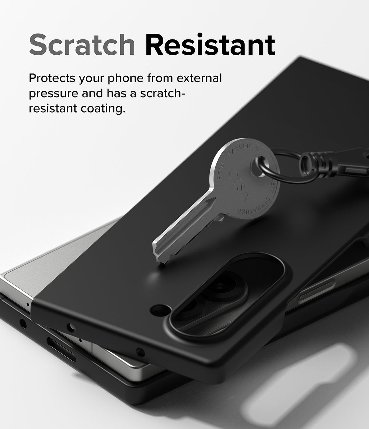 Galaxy Z Fold 6 Case | Slim Magnetic - A metal key resting on a matte black phone case, demonstrating scratch resistance.