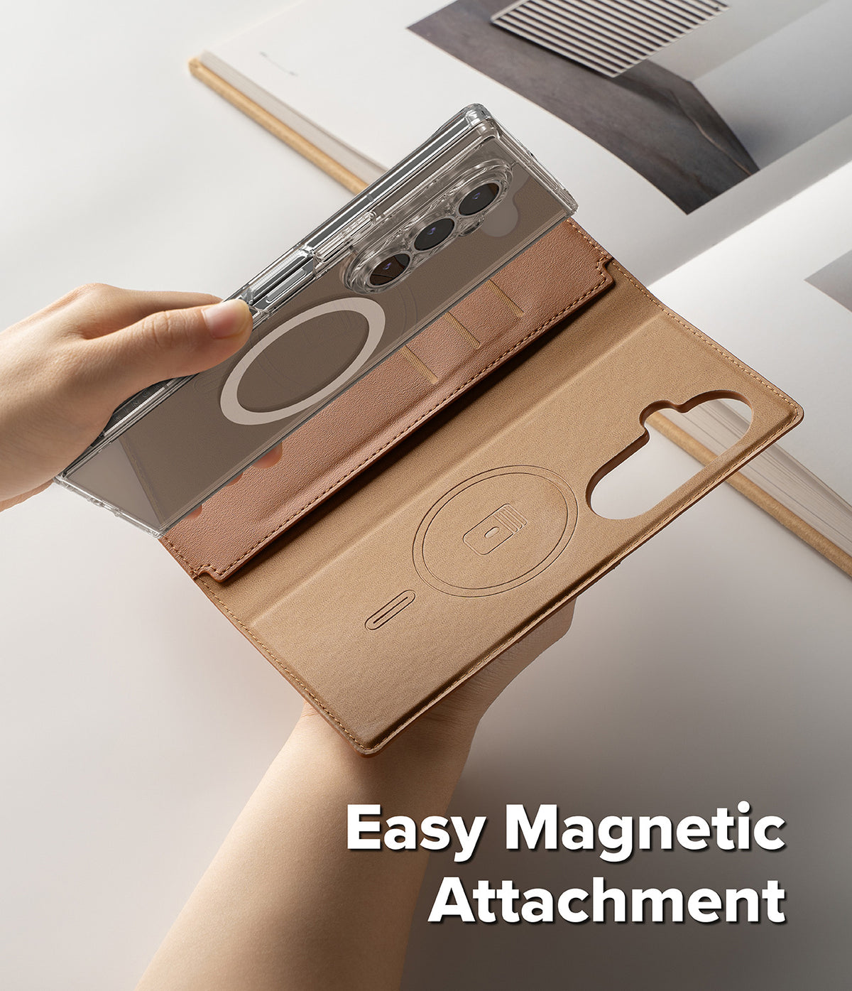 Galaxy Z Fold 7 Cover | Folio Grip Wallet Magnetic - A hand attaching a clear magnetic phone case to a tan leather folio wallet.