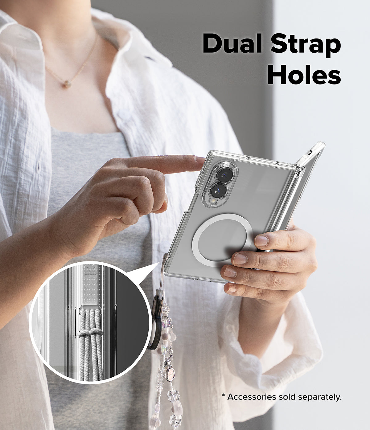 Galaxy Z Fold 8 Case | Fusion Flap Magnetic - A person holds a silver foldable smartphone in a clear protective case with a dangling charm and strap. The image includes the text 'Dual Strap Holes' and a circular inset showing a close-up of the strap attachment detail.