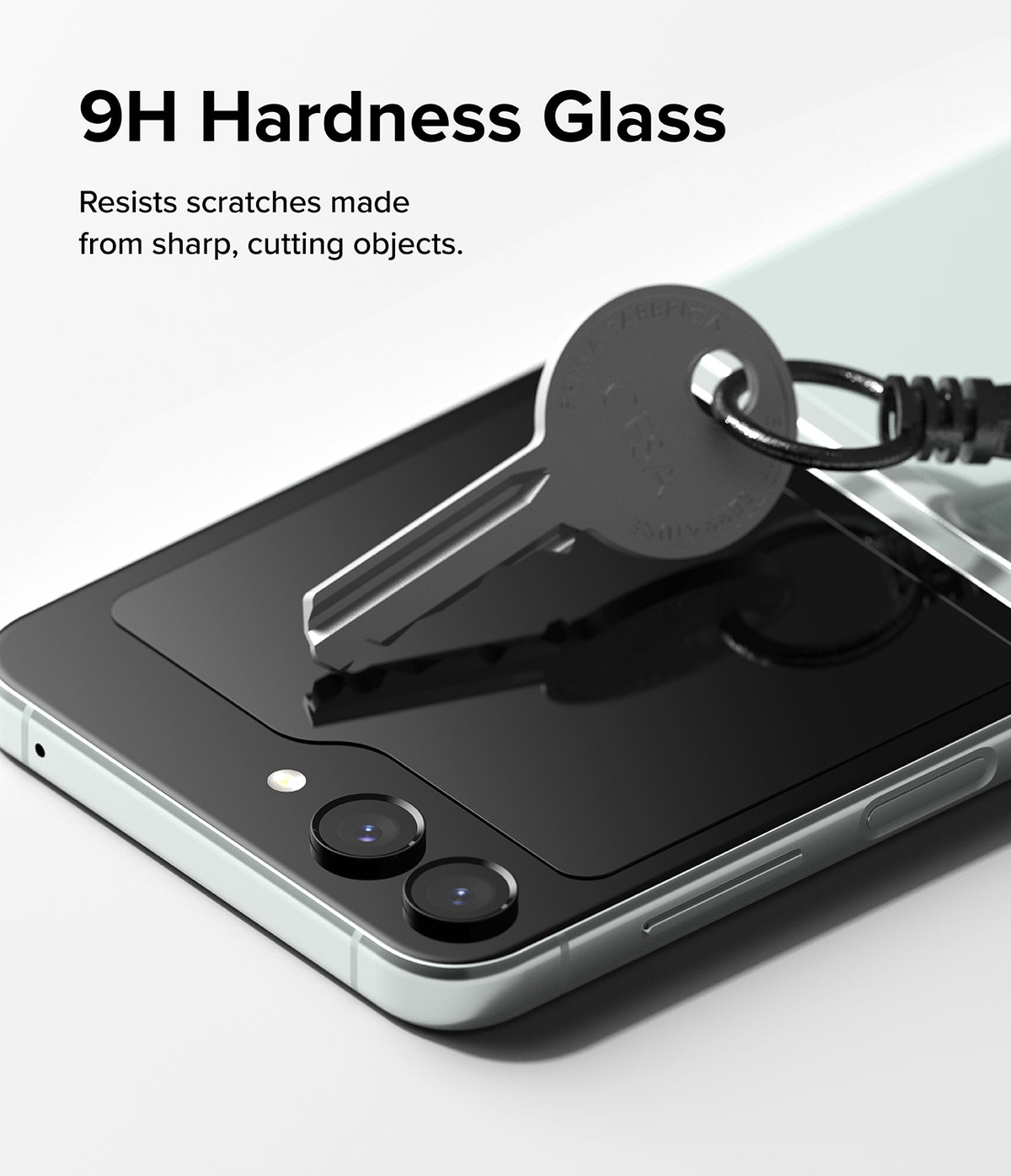 Galaxy Z Flip 5 Screen Protector | Cover Display Glass - Galaxy Z Flip 5 Screen Protector - A metal key pressing against the 9H glass cover display of a Galaxy Z Flip 5.