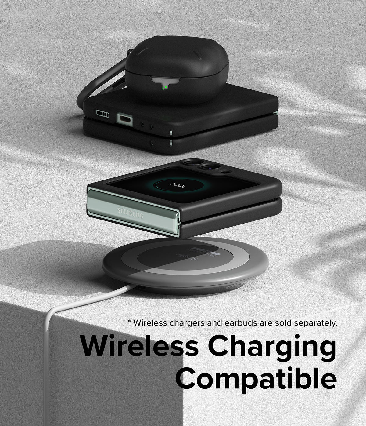 Galaxy Z Flip 5 Case | Slim - Folded phone in black case wirelessly charging above a pad with earbuds on top.