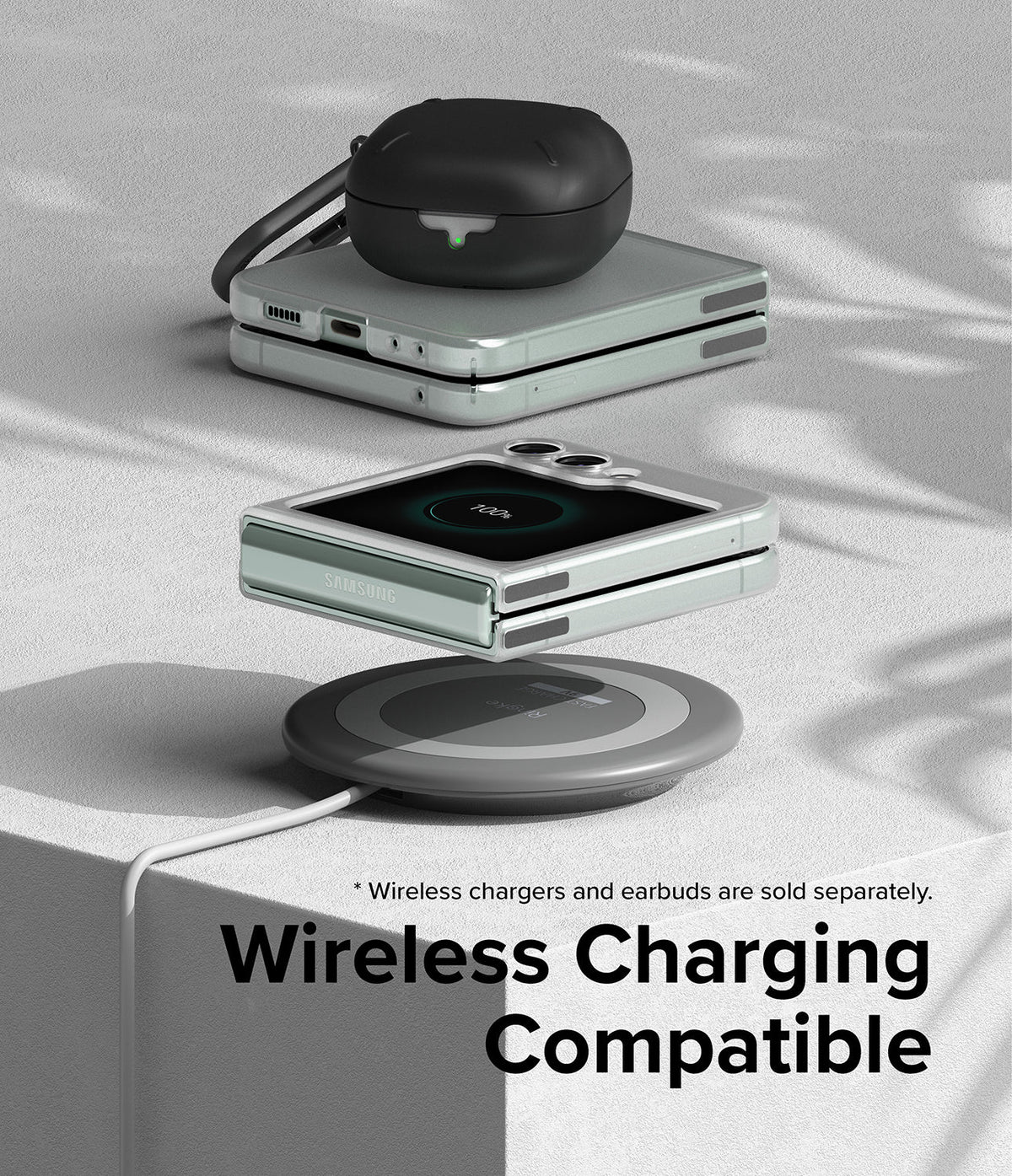 Galaxy Z Flip 5 Case | Slim - A folded Galaxy Z Flip 5 with earbuds on a wireless charging pad on a textured surface.