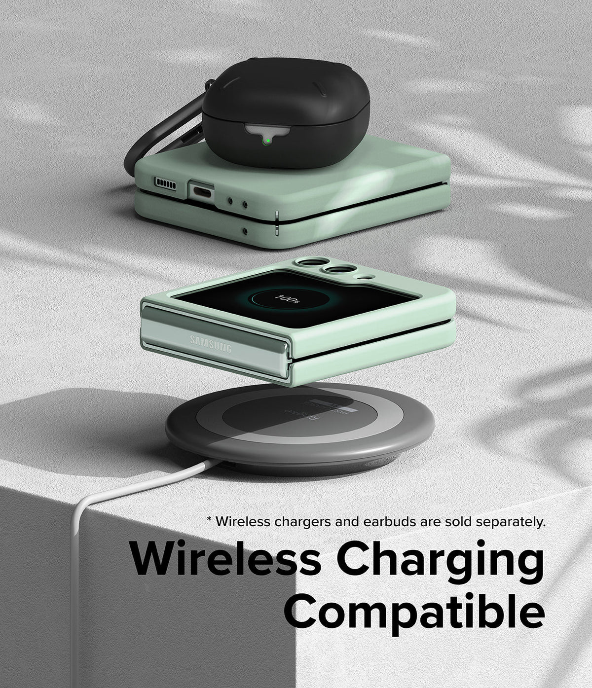 Galaxy Z Flip 5 Case | Slim Color - Mint green phone case on a wireless charger with black earbuds on top.